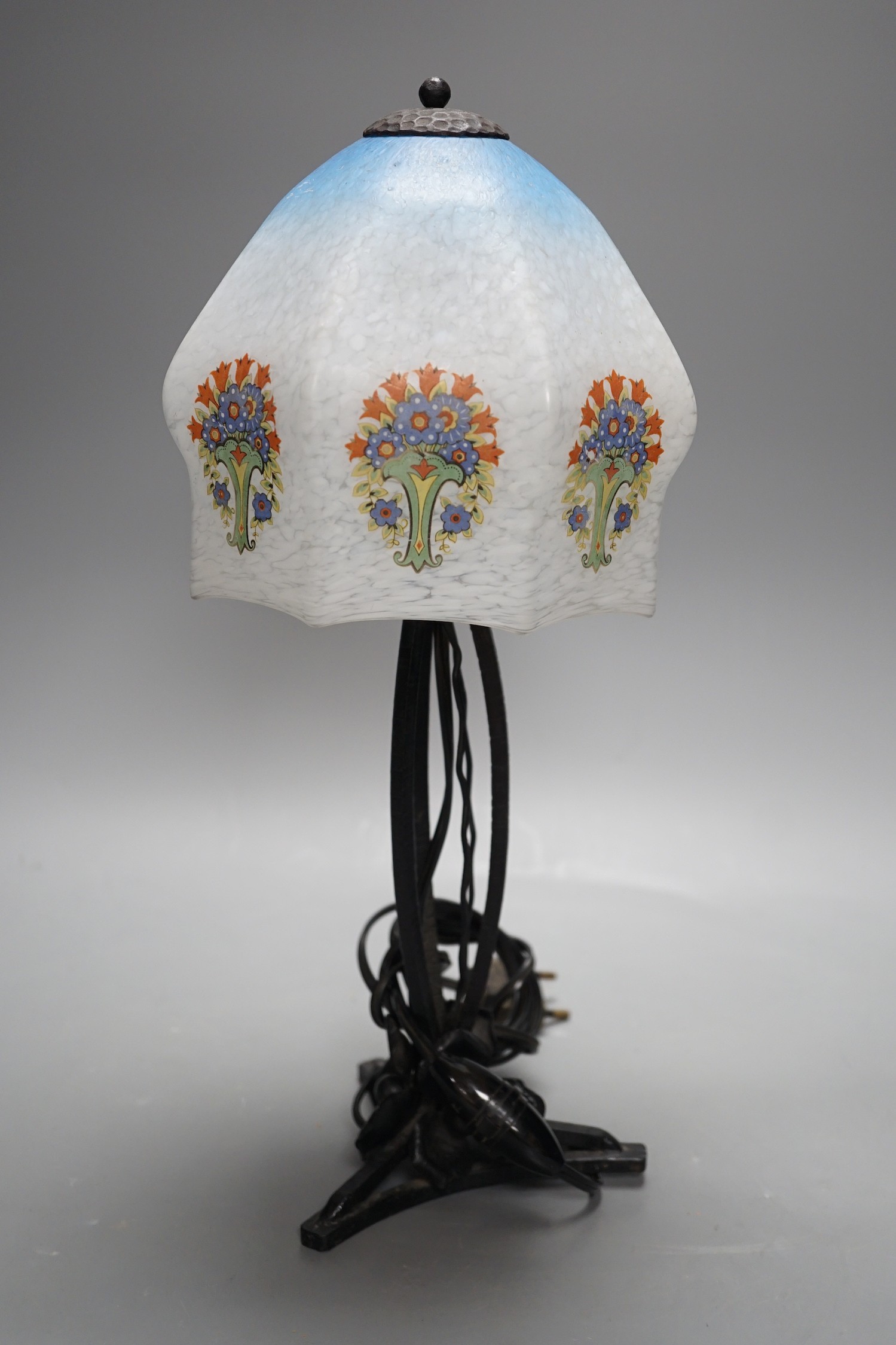 An Art Deco wrought iron table lamp on tripod base with frosted glass shade, 38cm tall